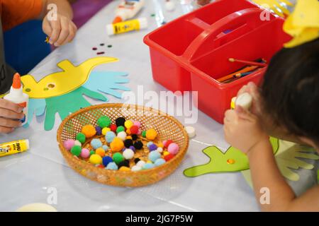 Dinosaurs kids crafts at summer school. Stock Photo