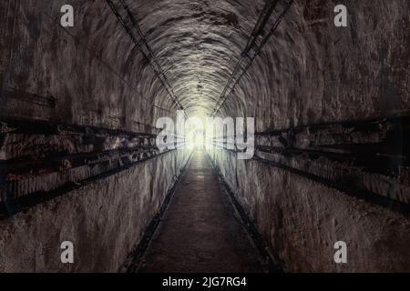 Exploration of a bunker from the second world war with a flashlight Stock Photo