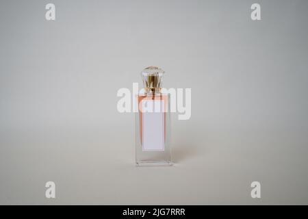 Orange Perfume bottle and cap for branding isolated on white background, Orange Perfume bottle mockup. Stock Photo