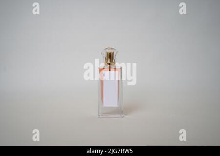 Orange Perfume bottle and cap for branding isolated on white background, Orange Perfume bottle mockup. Stock Photo