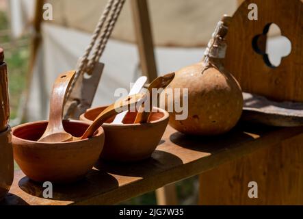 clay bowls with wooden spoons placed on a shelf Stock Photo