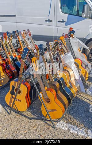 New Acoustic Guitars for Sale at Flea Market Stock Photo