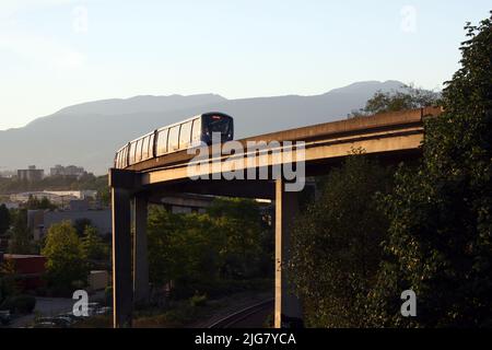 a SkyTrain moving on a bridge on a summer sunny day in Vancouver, British Columbia, Canada Stock Photo