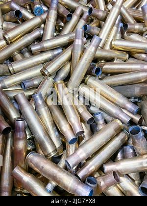 Used brass bullet cases from a rifle range, ready to be recycled. High quality image Stock Photo