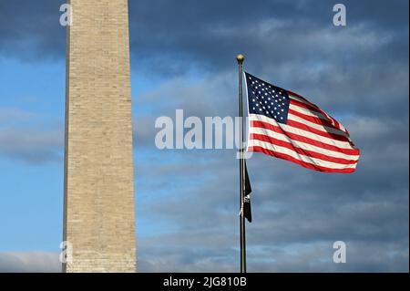 Washington Monument on the National Mall next to US Flag;Washington D.C. Stock Photo