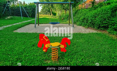 Childrens Playground with Horse and Swing in Lower Bavaria Germany Stock Photo