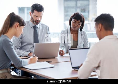 Meeting in session. Cropped shot of a group of businesspeople having a meeting in the boardroom. Stock Photo