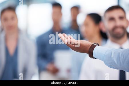 Closeup hand of unknown african american business manager training and presenting to team of businesspeople in office workshop. Black businessman Stock Photo