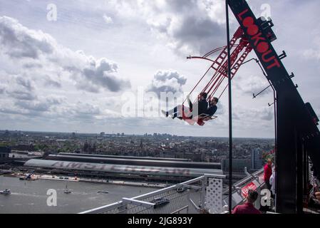 Netherlands, Amsterdam: Tourists swing at a height of 100 meters above Amsterdam. 'Over The Edge' is Europe's highest swing and a popular tourist attraction in Amsterdam's Noord district. Stock Photo