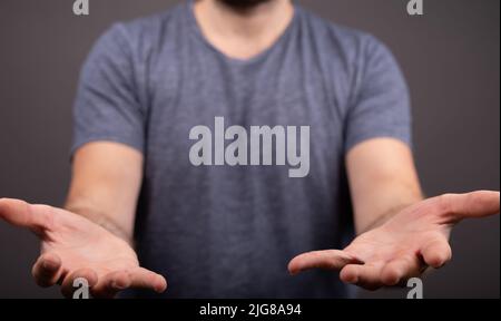 A closeup shot of a young guy opening his hands Stock Photo