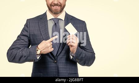 cropped man in suit pointing finger on empty debit or business card for copy space, advertisement. Stock Photo