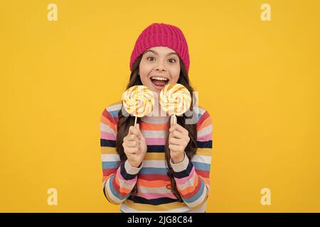 wow. happy teen girl hold lollipop. lollipop lady. hipster kid with colorful lollypop sugar candy Stock Photo