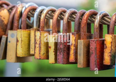 Love locks hang on the chain bridge in Bamberg Stock Photo