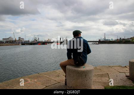 young man, dock, Quay, Dublin, Ireland Stock Photo