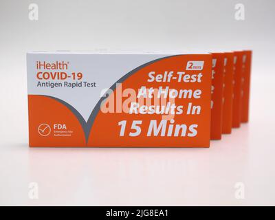 USA - July 8, 2022: Five new boxes containing iHealth brand COVID-19 antigen rapid tests are shown isolated against a white background. Stock Photo