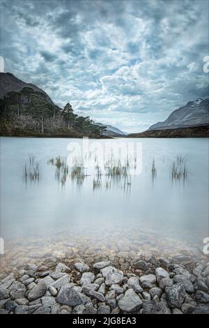 Photo of Loch Clair with views of the Torridon mountains (Beinn Eighe and Liathach) from across the water. Stock Photo