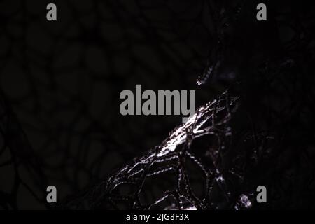 Wicker mesh of threads as a background with a soft blurred focus in the dark as a background ,abstract background Stock Photo