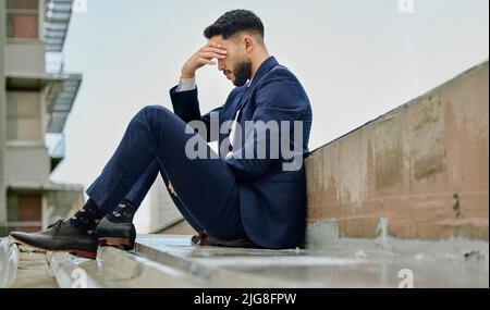This might be the end. Shot of a young businessman looking stressed out. Stock Photo