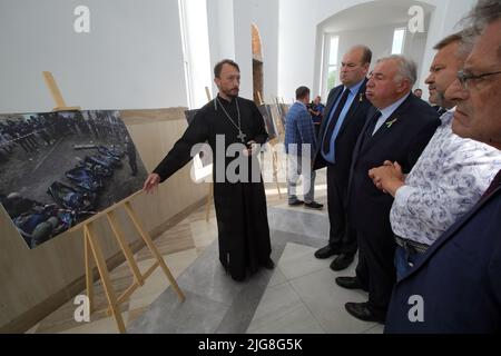 BUCHA, UKRAINE - JULY 8, 2022 - Head of the Church of Saint Andrew the First-Called Apostle Andrii Halavin shows President of the Senate of the French Stock Photo