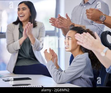 Positive thoughts create a positive environment. Shot of a group of businesspeople clapping in a meeting at work. Stock Photo