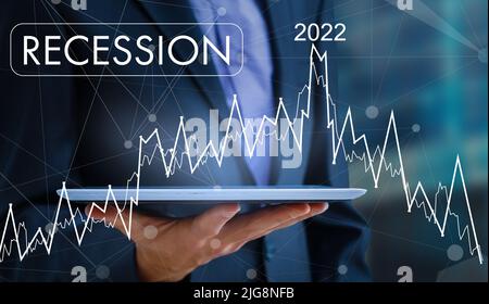 Economic crisis, Businessman using mobile smartphone analyzing sales data and economic graph chart that is falling, stock market crash caused. Stock Photo