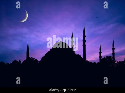 Mosques Dome on dark blue twilight sky and Crescent Moon on background, symbol islamic religion Ramadan and free space for text arabic, Eid al-Adha Stock Photo