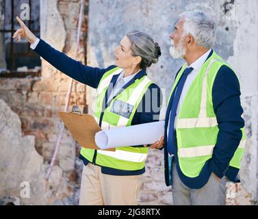 Motivation determines what you do. Shot of two engineers working on a site. Stock Photo