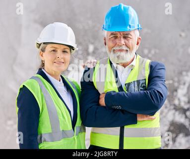 Ability is what youre capable of doing. Shot of engineers standing with their arms folded on a construction site. Stock Photo