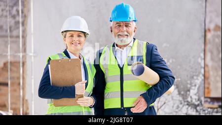 Quality means doing it right. Shot of engineers standing with blueprints on a construction site. Stock Photo