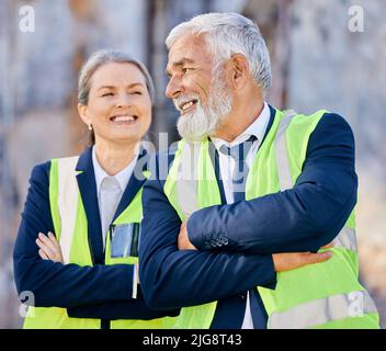 Attitude determines how well you do it. Shot of engineers standing with their arms folded on a construction site. Stock Photo