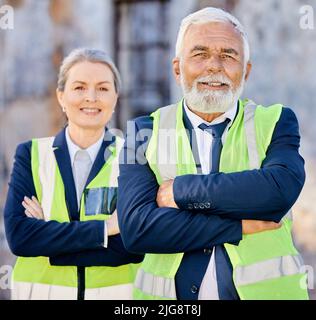 Every accomplishment starts with the decision to try. Shot of engineers standing with their arms folded on a construction site. Stock Photo