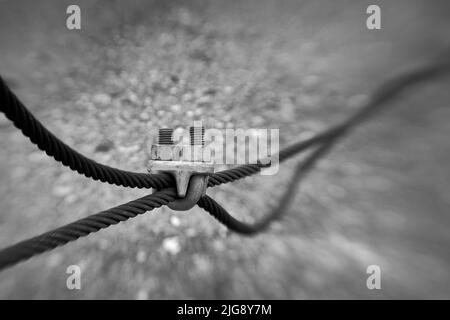 Selected focus of cables held in place by steel clamp Stock Photo