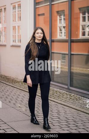 Portrait of young confident woman on a street Stock Photo