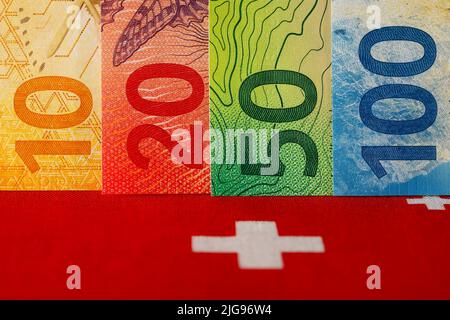 The symbol of the Swiss flag completes the view of the Swiss banknotes of various denominations. These new banknotes are the eighth series of banknote Stock Photo