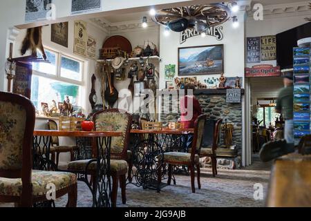 Otira, New Zealand - May 5 2022; Artifact crowded interior of historic Stagecoach Hotel on main highway through Arthurs Pass. Stock Photo