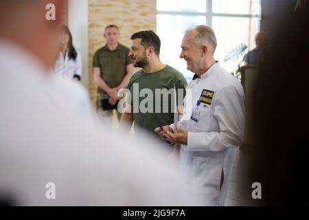 Dnipro, Ukraine. 08th July, 2022. Ukrainian President Volodymyr Zelenskyy, is escorted by Dr. Serhiy Ryzhenko as he meets with medical staff and visits wounded warriors during a visit to the Mechnikov Hospital, July 8, 2022 in Dnipro, Dnipropetrovsk, Ukraine. Credit: Ukraine Presidency/Ukrainian Presidential Press Office/Alamy Live News Stock Photo