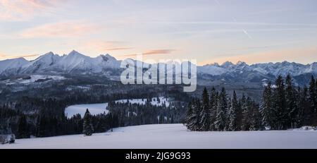 Beautiful winter landscape with snowy mountains and forest during sunrise, Europe, Slovakia Stock Photo