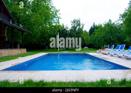 The concept idea of having a pleasant holiday thanks to the garden with the pool and the garden with the pool in the detached house Stock Photo