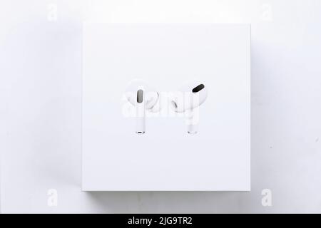 KHARKIV, UKRAINE - JANUARY 27, 2021: Apple AirPods Pro on a white background. Wireless headphones with charging case and a box. Apple Inc. is an Ameri Stock Photo