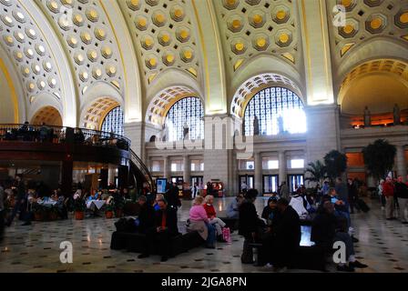 People wait under the high arched ceilings of Union Station in Washington DC, the city's main railroad and train state Stock Photo