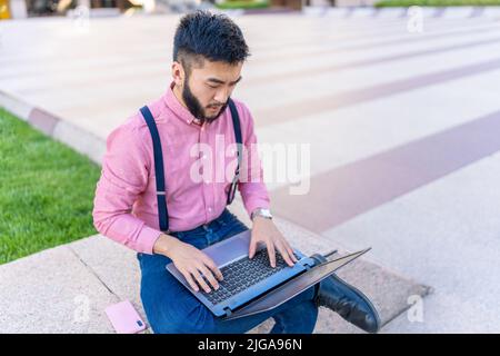 Top view of an asian man using a laptop Stock Photo