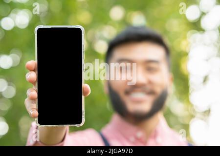 Screen of a mobile phone held by an man Stock Photo