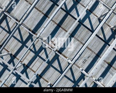 Aerial Photo Busy Industrial Construction Site. Factory Building. Construction Site with Cranes and Heavy Equipment. Stock Photo