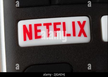 New York, USA - July 14, 2022: Detail of remote control with Netflix button. Netflix is an international leading subscription service for watching TV Stock Photo