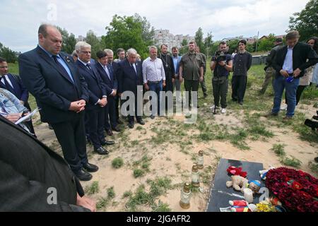 BUCHA, UKRAINE - JULY 8, 2022 - Members of the delegation of the Senate of the French Parliament visit the mass burial sites of civilians killed by Russian invaders located near the Church of Saint Andrew the First-Called Apostle and All Saints, Bucha, Kyiv Region, northern Ukraine. Photo by Pavlo Bagmut/Ukrinform/ABACAPRESS.COM Stock Photo