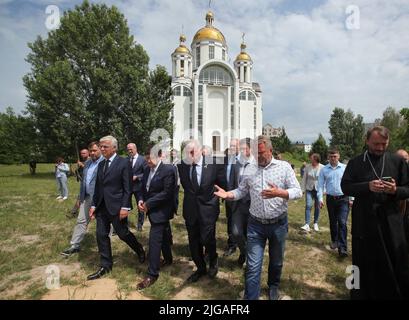 BUCHA, UKRAINE - JULY 8, 2022 - Members of the delegation of the Senate of the French Parliament headed by President of the Senate of the French Republic Gerard Larcher (C) visit the mass burial sites of civilians killed by Russian invaders located near the Church of Saint Andrew the First-Called Apostle and All Saints, Bucha, Kyiv Region, northern Ukraine. Photo by Pavlo Bagmut/Ukrinform/ABACAPRESS.COM Stock Photo