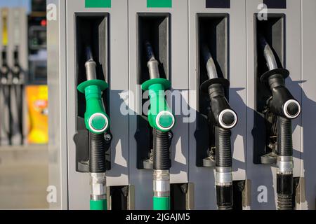 Shallow depth of field (selective focus) details with fuel pumps at a gas station. Stock Photo