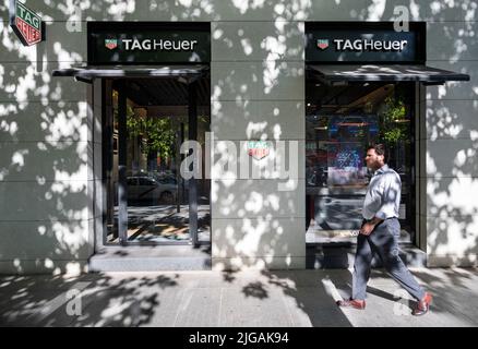 A pedestrian walks past the Swiss luxury watchmaker brand Tag