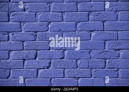 Section of brick wall painted purple, in bright sun on the Gold Coast, Queensland, Australia. Background, copy space. Stock Photo