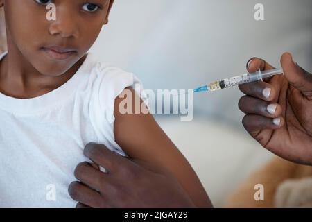 Theres nothing to be afraid of. an unrecognizable doctor giving a patient an injection at a hospital. Stock Photo